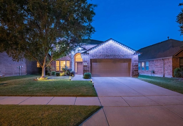 925 Lake Grove Dr, Little Elm, TX 75068 - view of front of property with brick siding, a garage, a front yard, and concrete driveway