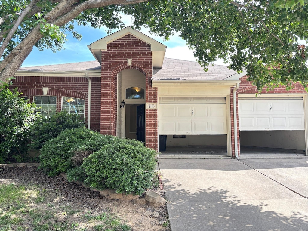 817 Fox Hunt Trl, Fort Worth, TX 76179 - view of front of home featuring brick siding, driveway, roof with shingles, and a garage