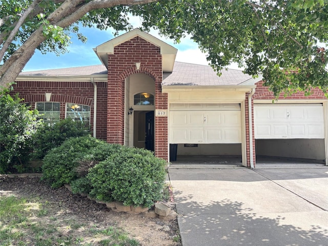 817 Fox Hunt Trl, Fort Worth, TX 76179 - view of front of home featuring brick siding, driveway, roof with shingles, and a garage