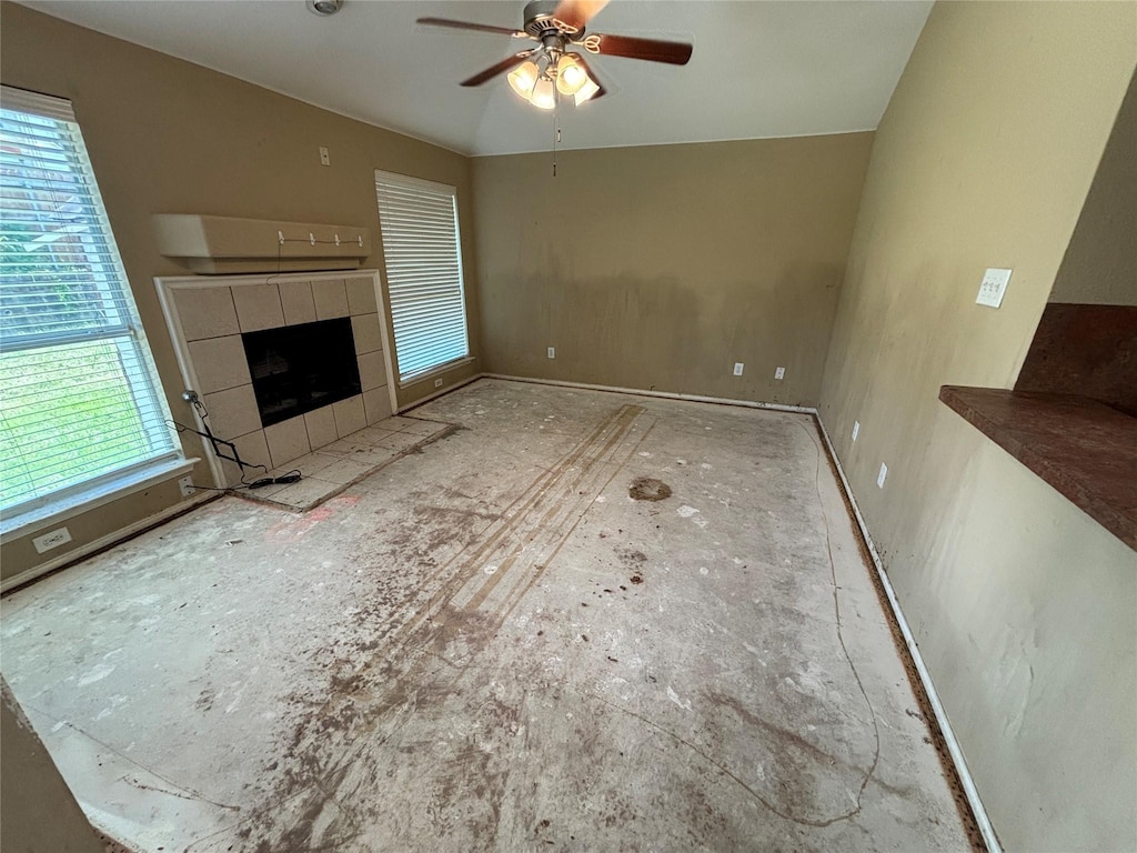 817 Fox Hunt Trl, Fort Worth, TX 76179 - unfurnished living room featuring healthy amount of natural light, ceiling fan, and a tile fireplace