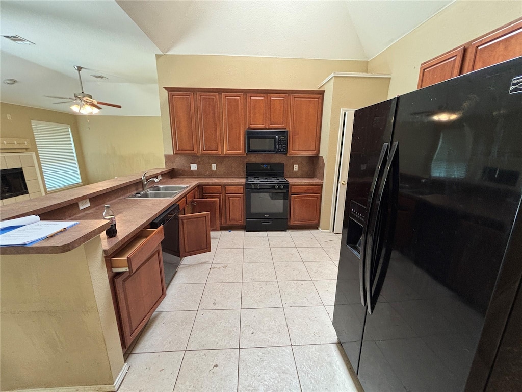 817 Fox Hunt Trl, Fort Worth, TX 76179 - kitchen with black appliances, a sink, a peninsula, brown cabinets, and vaulted ceiling