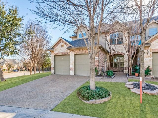 6101 Eagle Nest Dr, Garland, TX 75044 - traditional home featuring driveway, an attached garage, a front lawn, stone siding, and brick siding