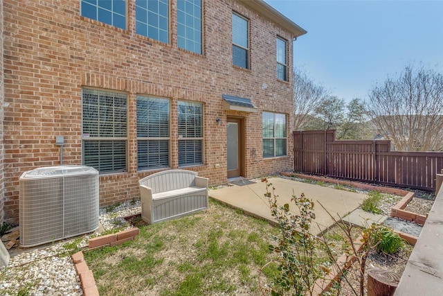6101 Eagle Nest Dr, Garland, TX 75044 - rear view of house with central air condition unit, a patio area, and brick siding