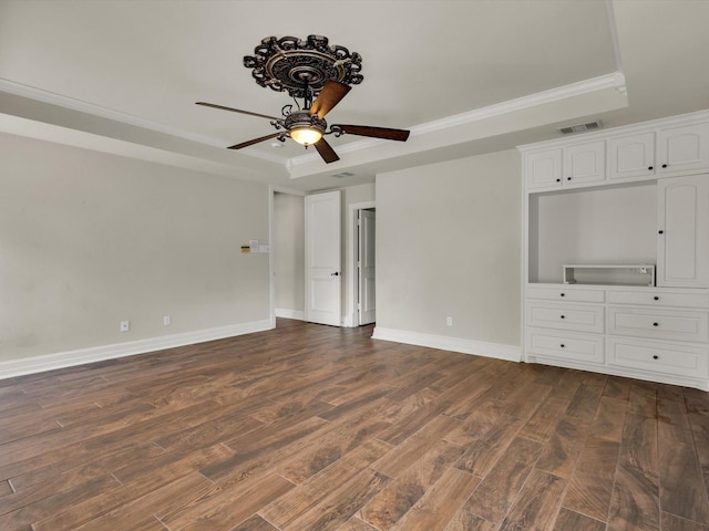 501 Las Lomas Dr, Heath, TX 75032 - spare room with a raised ceiling, crown molding, dark wood-style flooring, and a ceiling fan