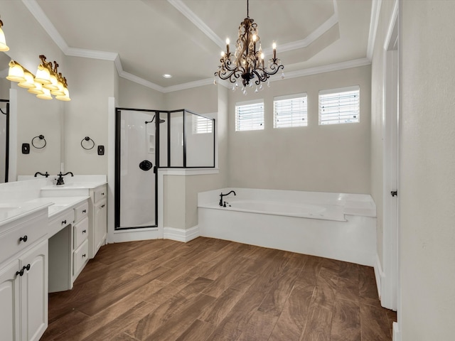 501 Las Lomas Dr, Heath, TX 75032 - bathroom with a bath, a stall shower, double vanity, a chandelier, and wood finished floors