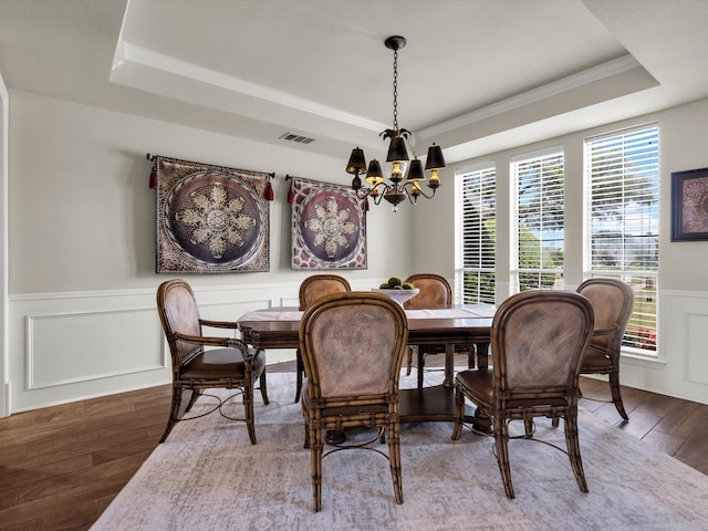 501 Las Lomas Dr, Heath, TX 75032 - dining space featuring a raised ceiling, hardwood / wood-style floors, a chandelier, wainscoting, and crown molding