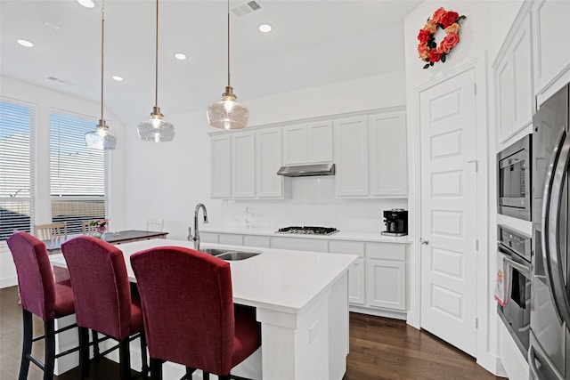3514 Charleston Dr, Melissa, TX 75454 - kitchen featuring a sink, stainless steel appliances, a center island with sink, under cabinet range hood, and a breakfast bar area
