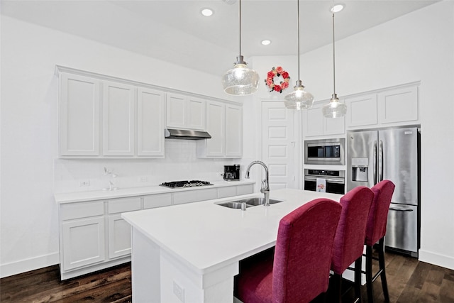 3514 Charleston Dr, Melissa, TX 75454 - kitchen featuring stainless steel appliances, a sink, under cabinet range hood, pendant lighting, and a kitchen island with sink