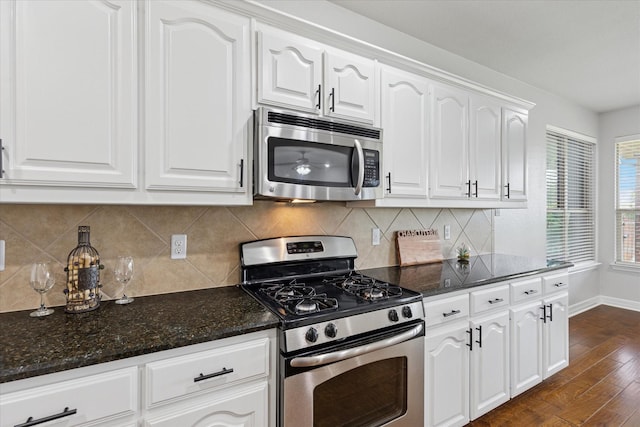2256 Laurel Forest Dr, Fort Worth, TX 76177 - kitchen with appliances with stainless steel finishes, dark stone countertops, white cabinetry, and dark wood-style flooring