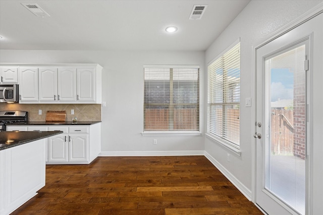 2256 Laurel Forest Dr, Fort Worth, TX 76177 - kitchen with appliances with stainless steel finishes, dark countertops, dark wood finished floors, white cabinetry, and recessed lighting