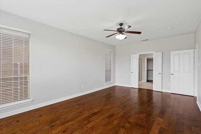 2256 Laurel Forest Dr, Fort Worth, TX 76177 - unfurnished bedroom with dark wood-type flooring, baseboards, ceiling fan, and a walk in closet