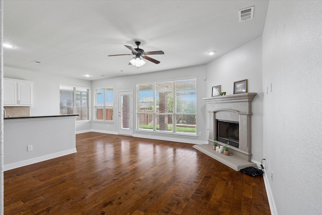2256 Laurel Forest Dr, Fort Worth, TX 76177 - unfurnished living room featuring baseboards, ceiling fan, wood finished floors, a fireplace with raised hearth, and recessed lighting