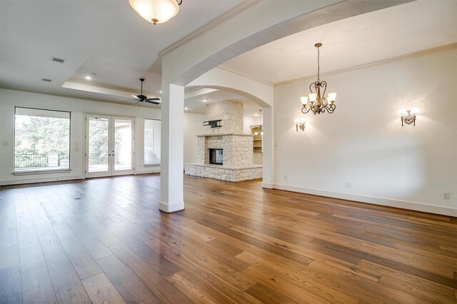 6005 Selkirk Ct, Cleburne, TX 76033 - unfurnished living room with crown molding, ceiling fan, hardwood / wood-style floors, a stone fireplace, and baseboards