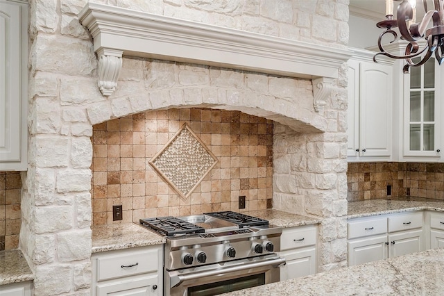 6005 Selkirk Ct, Cleburne, TX 76033 - kitchen featuring high end range, tasteful backsplash, white cabinetry, and crown molding