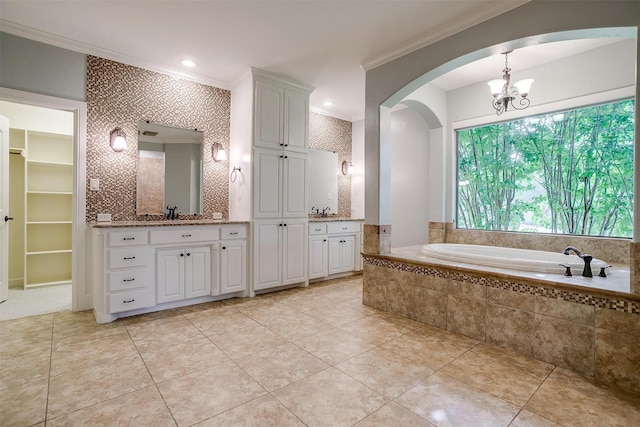 6005 Selkirk Ct, Cleburne, TX 76033 - bathroom featuring crown molding, vanity, a garden tub, a chandelier, and tile patterned floors