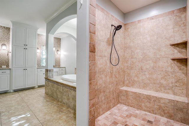 6005 Selkirk Ct, Cleburne, TX 76033 - bathroom featuring a tile shower, a bath, ornamental molding, tile patterned floors, and vanity