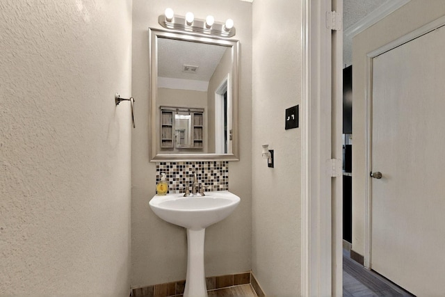 2908 Quail Run Dr, Mesquite, TX 75149 - bathroom with a textured wall and tasteful backsplash