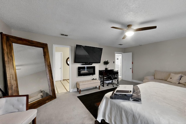 2908 Quail Run Dr, Mesquite, TX 75149 - carpeted bedroom with a textured ceiling, baseboards, and a ceiling fan