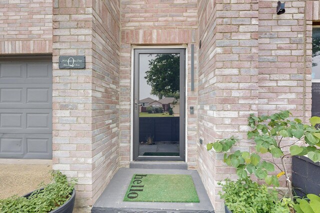 2908 Quail Run Dr, Mesquite, TX 75149 - doorway to property with brick siding and a garage