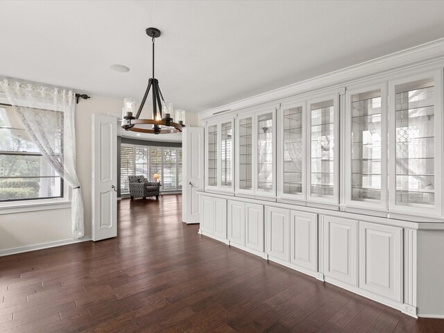 736 Westwood Dr, Sherman, TX 75092 - unfurnished dining area featuring a chandelier, dark wood finished floors, and baseboards
