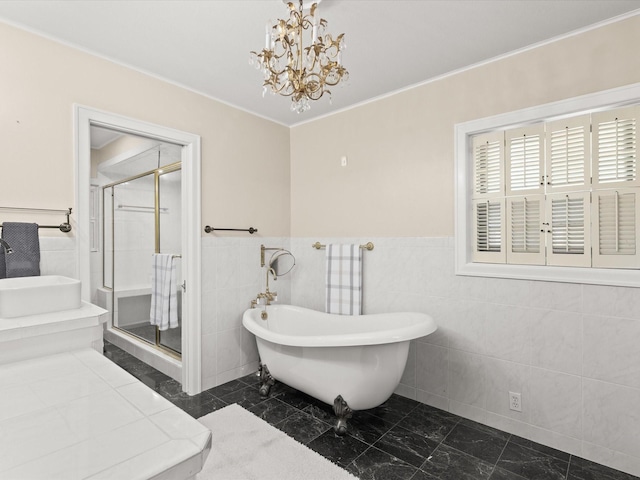 736 Westwood Dr, Sherman, TX 75092 - bathroom with a freestanding bath, a chandelier, a stall shower, tile walls, and marble look tile flooring