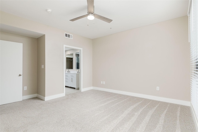 4605 Cedar Springs Rd Unit 201, Dallas, TX 75219 - unfurnished bedroom featuring light carpet, baseboards, connected bathroom, and a ceiling fan