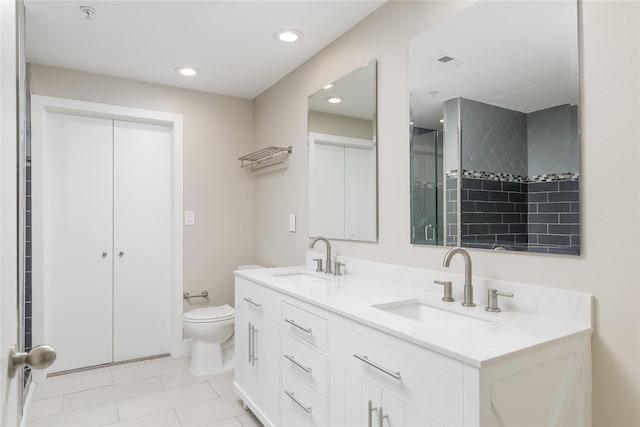 4605 Cedar Springs Rd Unit 201, Dallas, TX 75219 - full bath featuring double vanity, toilet, tile patterned flooring, and recessed lighting