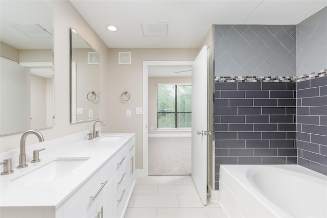 4605 Cedar Springs Rd Unit 201, Dallas, TX 75219 - bathroom featuring tile patterned flooring, double vanity, baseboards, and recessed lighting
