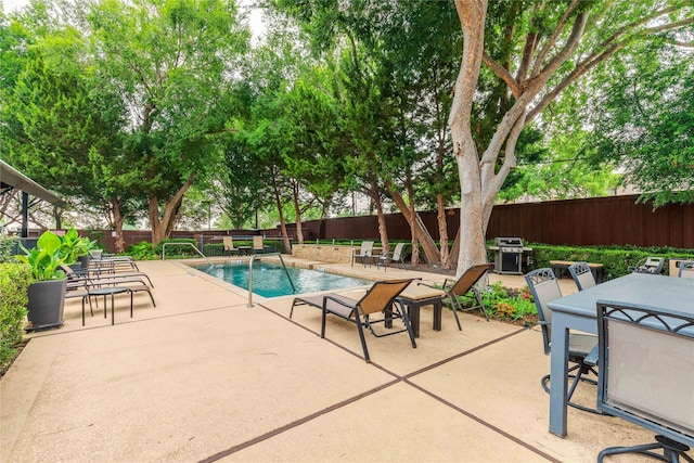 4605 Cedar Springs Rd Unit 201, Dallas, TX 75219 - community pool featuring a patio area, a fenced backyard, area for grilling, and outdoor dining space