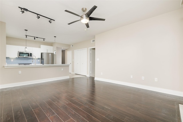 4605 Cedar Springs Rd Unit 201, Dallas, TX 75219 - unfurnished living room with rail lighting, ceiling fan, wood finished floors, baseboards, and a sink