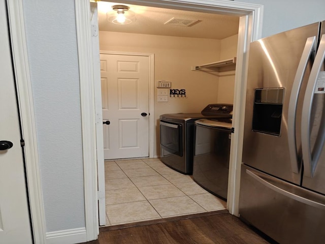 4415 Shady Elm Dr, Mansfield, TX 76063 - washroom with washer and clothes dryer and light wood-type flooring