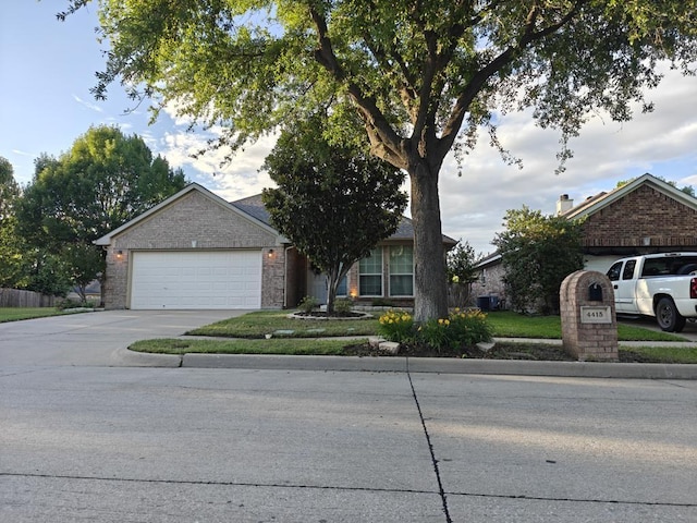 4415 Shady Elm Dr, Mansfield, TX 76063 - obstructed view of property featuring an attached garage, concrete driveway, and brick siding