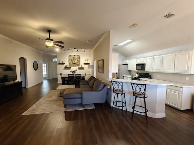 4415 Shady Elm Dr, Mansfield, TX 76063 - living room with dark wood-style flooring, a ceiling fan, ornamental molding, arched walkways, and track lighting