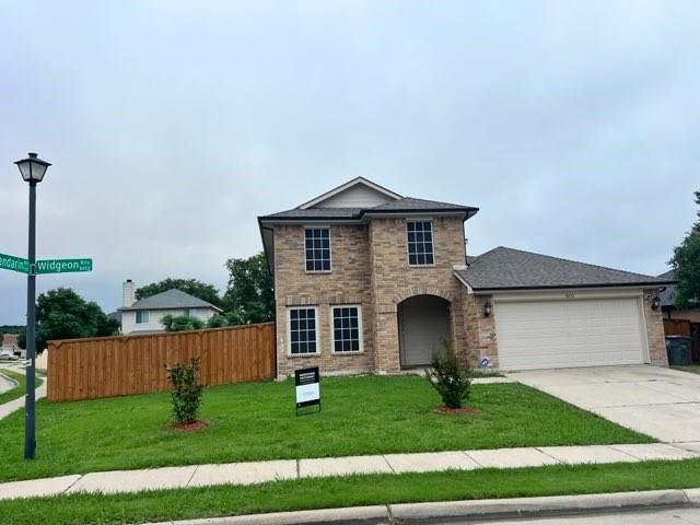 8412 Widgeon Way, Dallas, TX 75249 - view of front of property with an attached garage, concrete driveway, and stone siding