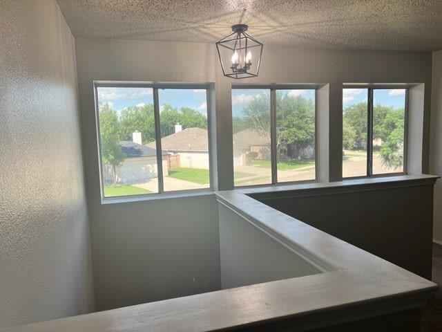 8412 Widgeon Way, Dallas, TX 75249 - interior space featuring a chandelier