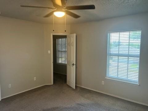 8412 Widgeon Way, Dallas, TX 75249 - empty room featuring a ceiling fan, healthy amount of natural light, and carpet flooring