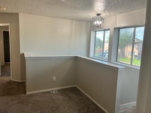 8412 Widgeon Way, Dallas, TX 75249 - unfurnished dining area featuring carpet, a chandelier, and a textured ceiling