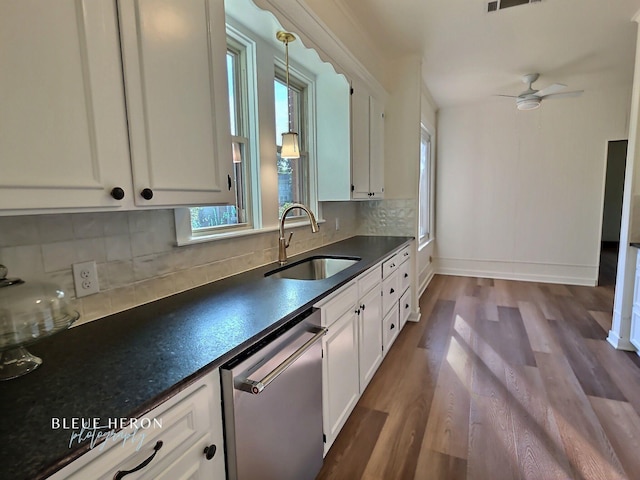 129 Ardmore Ave, Shreveport, LA 71105 - kitchen with stainless steel dishwasher, a sink, dark countertops, dark wood-style flooring, and white cabinetry