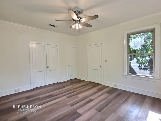 129 Ardmore Ave, Shreveport, LA 71105 - unfurnished bedroom with dark wood finished floors, ornamental molding, a ceiling fan, and baseboards