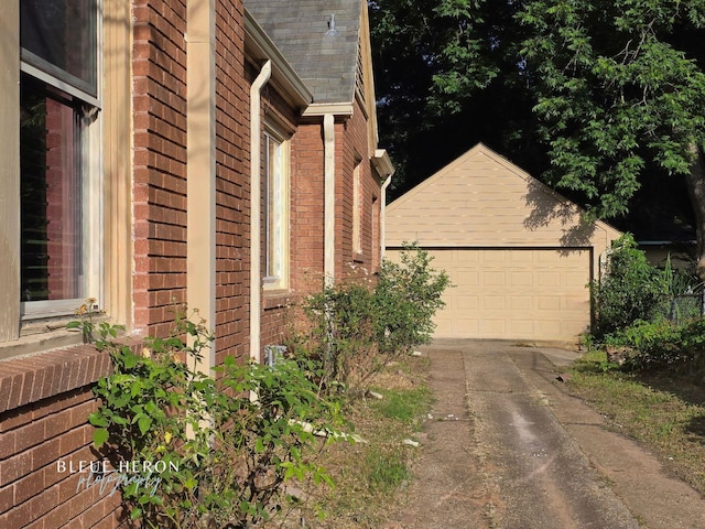 129 Ardmore Ave, Shreveport, LA 71105 - view of side of home with brick siding, an outdoor structure, and a garage
