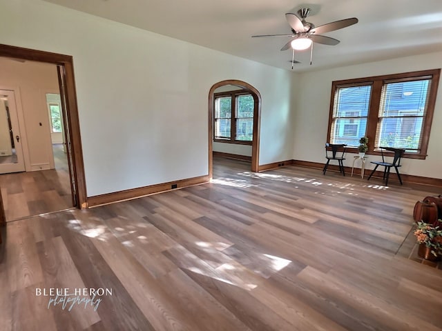 129 Ardmore Ave, Shreveport, LA 71105 - spare room with arched walkways, wood finished floors, ceiling fan, and baseboards