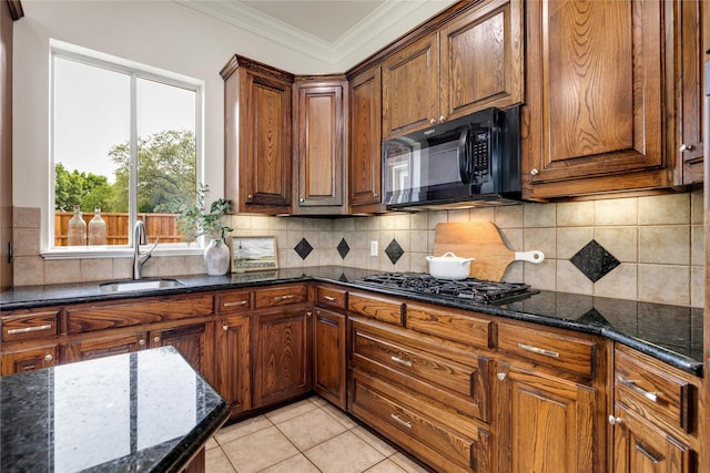 6408 Riverside Dr, Plano, TX 75024 - kitchen with a sink, black appliances, dark stone countertops, crown molding, and decorative backsplash