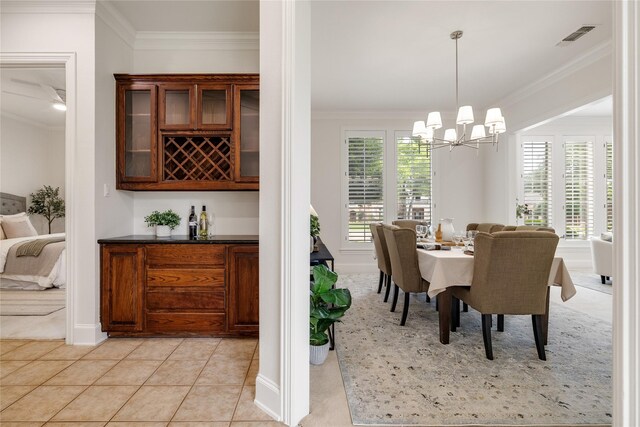 6408 Riverside Dr, Plano, TX 75024 - dining area featuring crown molding, a bar, a chandelier, baseboards, and light tile patterned floors