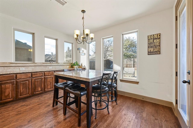 13818 Mammoth Cave Ln, Frisco, TX 75035 - dining room featuring a chandelier, dark wood-style flooring, and baseboards