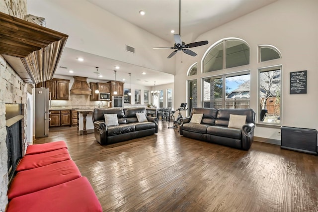13818 Mammoth Cave Ln, Frisco, TX 75035 - living room with a ceiling fan, dark wood-style flooring, a fireplace, recessed lighting, and a towering ceiling