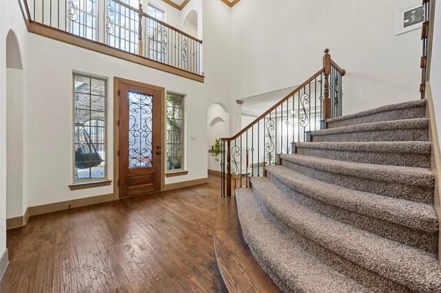 13818 Mammoth Cave Ln, Frisco, TX 75035 - foyer with hardwood / wood-style flooring, arched walkways, stairs, and a high ceiling