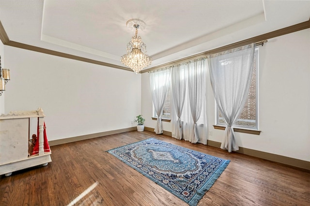13818 Mammoth Cave Ln, Frisco, TX 75035 - unfurnished room with a tray ceiling, a chandelier, baseboards, and wood finished floors
