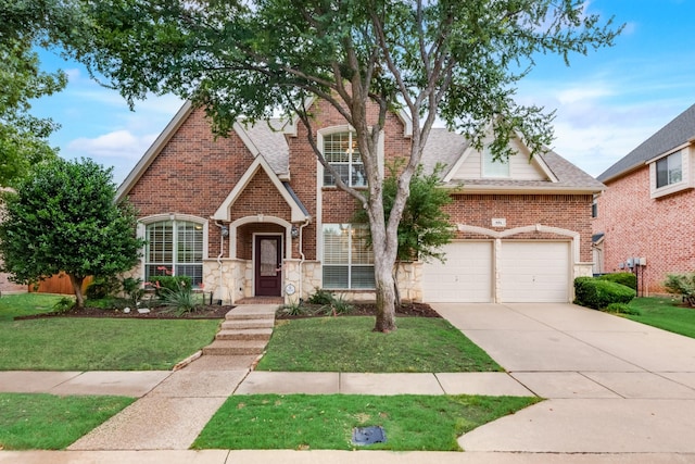 851 Carolina Way, Lantana, TX 76226 - view of front of property featuring driveway, a front lawn, stone siding, and brick siding