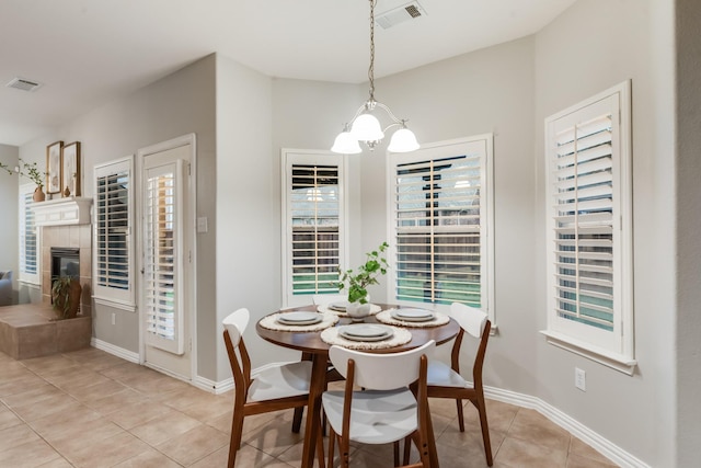 851 Carolina Way, Lantana, TX 76226 - dining space featuring a chandelier, light tile patterned floors, a fireplace, and baseboards