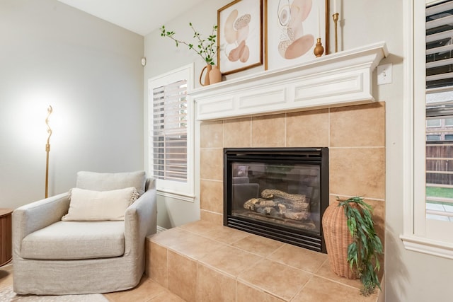 851 Carolina Way, Lantana, TX 76226 - living area featuring a tiled fireplace, lofted ceiling, and tile patterned flooring